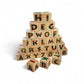Stack of wooden alphabet blocks with colorful letters on a white background