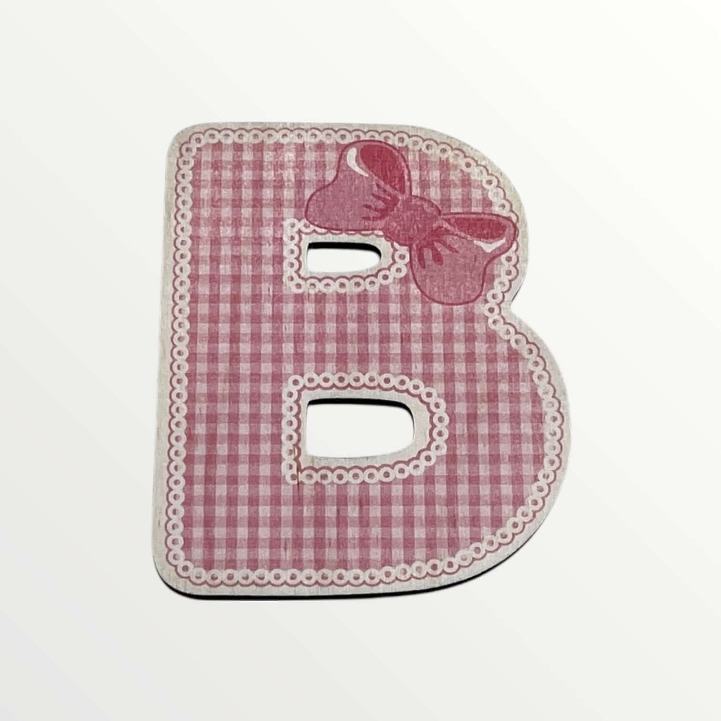 Pink checkered letter 'B' with a bow on a white background