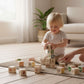 Child playing with ABC-123 Wooden blocks - 36 pcs, stacking blocks with colorful pictures in a cozy room.