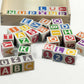ABC-123 Wooden blocks - 36 pcs scattered around a wooden box showing colorful letters and numbers.