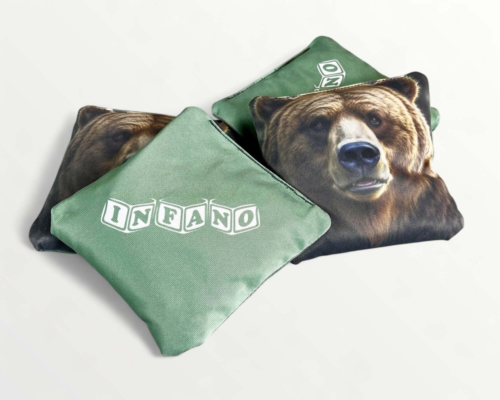 Cornhole Bags – Set of 4 featuring bear design with 'INFANO' logo on green fabric.