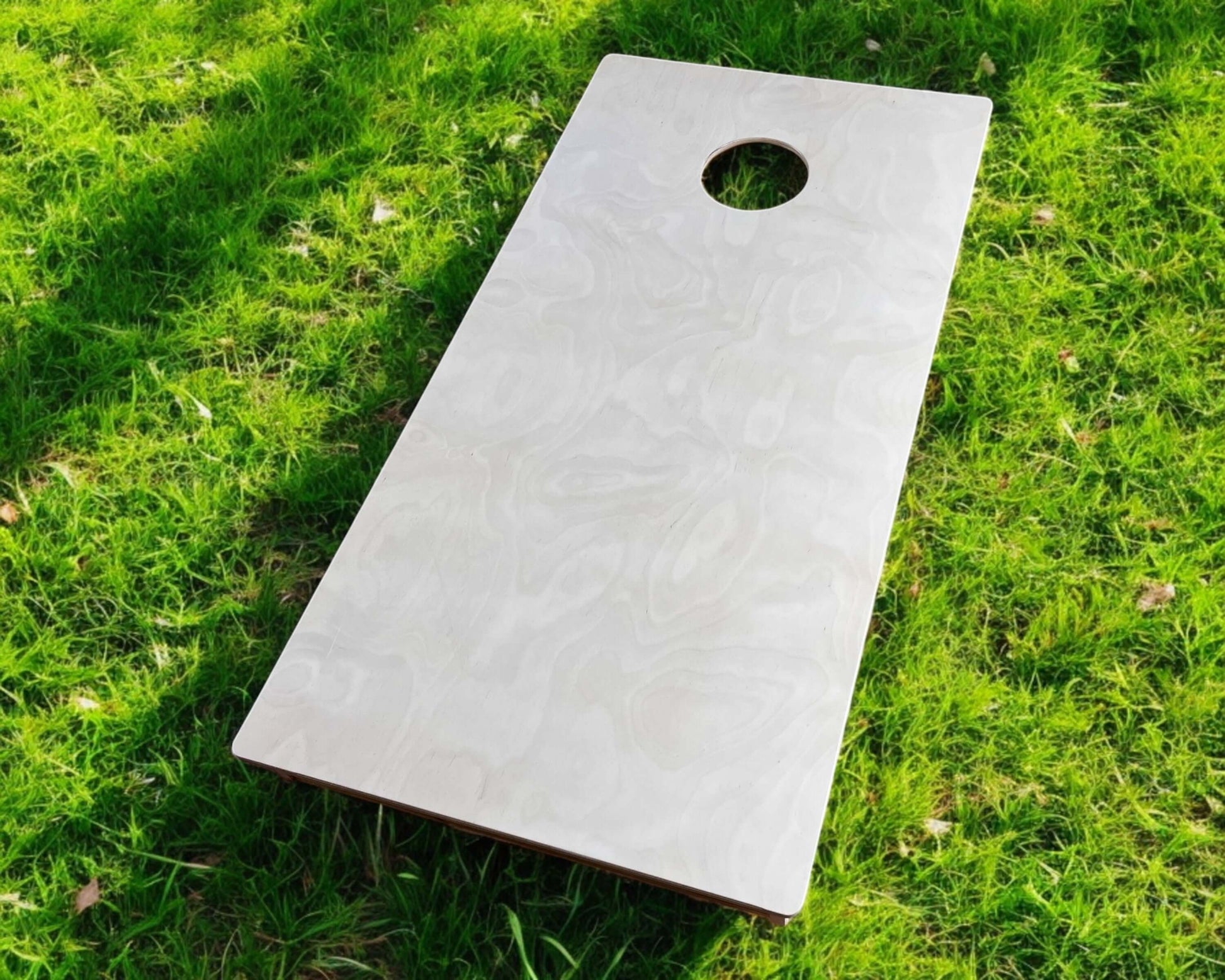 Cornhole Board - 120x60 cm on green grass, designed for skill-based tossing games.