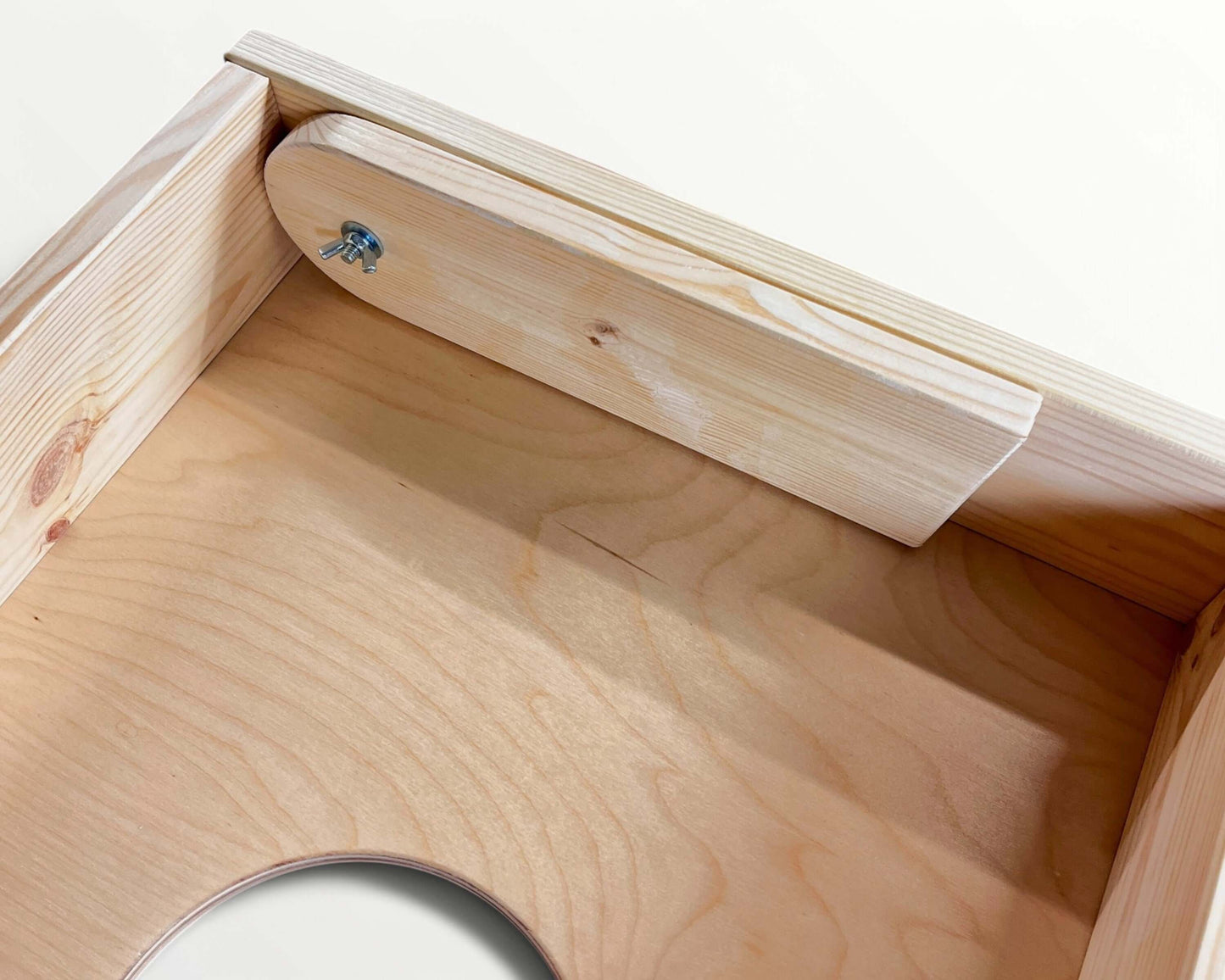 Close-up view of the interior of a Cornhole Board - 120x60 cm showcasing wooden construction and design details.