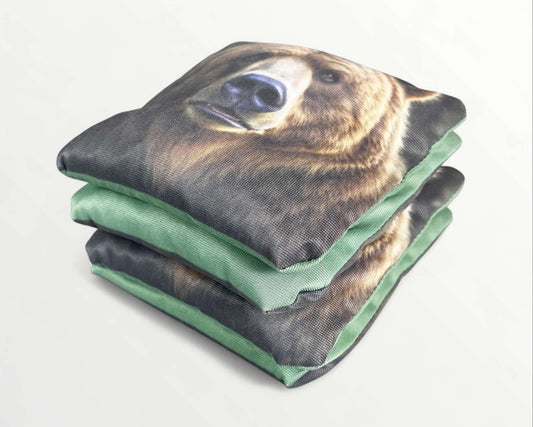 Cornhole Bags – Set of 4 featuring a bear design with green backing, perfect for outdoor games.