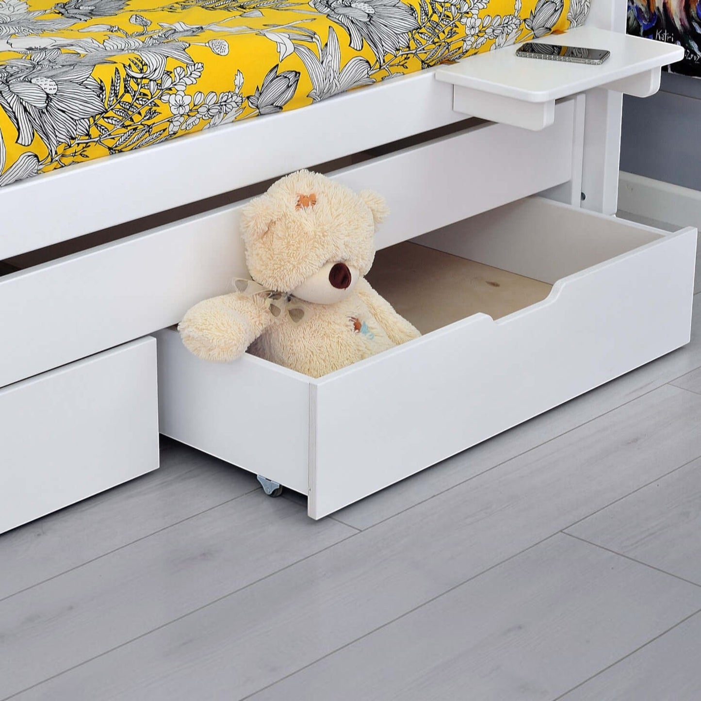 Infano Jerwen compact bed with white wooden frame, under-bed storage drawer, and a teddy bear inside.