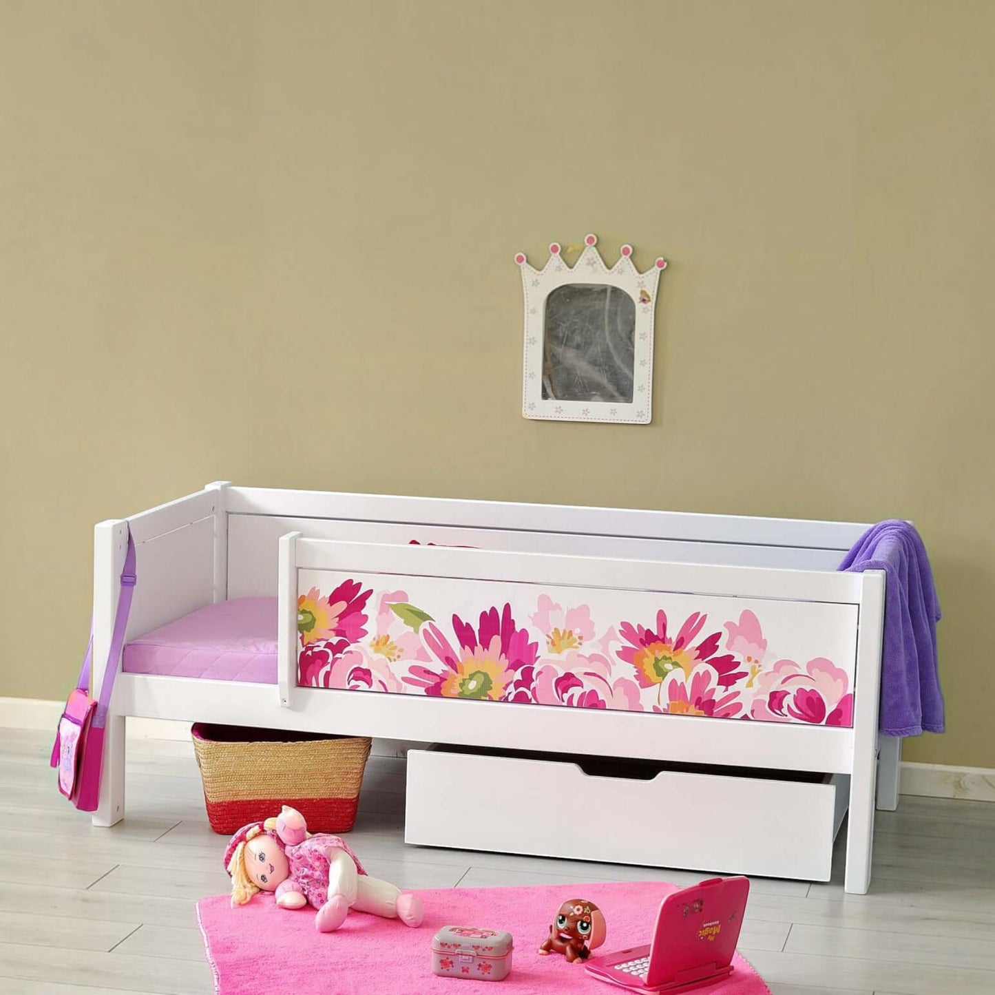Infano Jerwen white junior bed with floral safety barrier, storage drawer, and solid birch wood frame in a playroom.