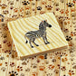 Memory game - Animals: Close-up of a wooden card featuring a zebra for the educational memory game.
