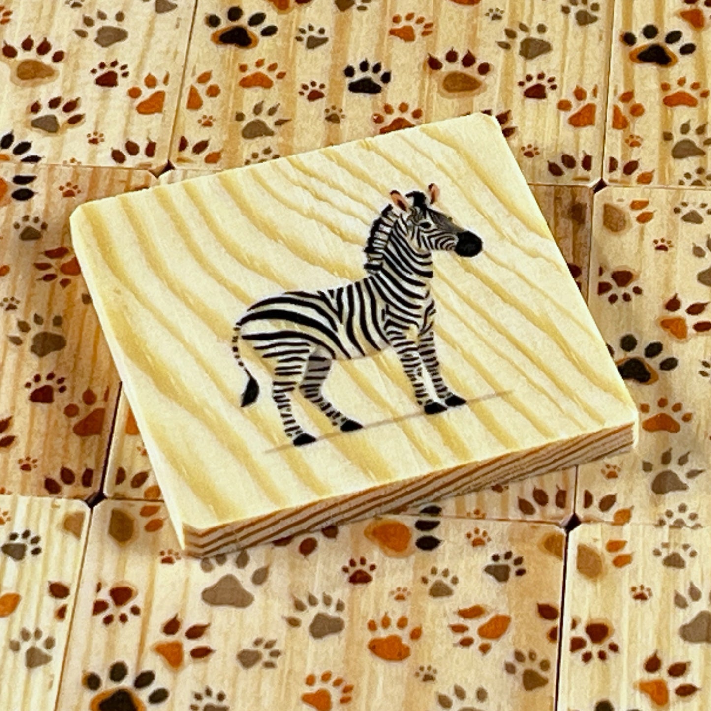 Memory game - Animals: Close-up of a wooden card featuring a zebra for the educational memory game.