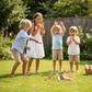 Throwing game - Scatter kids playing in the garden, enjoying a sunny day outdoors with colorful game sticks.