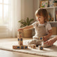Child playing with wooden blocks in a bright room