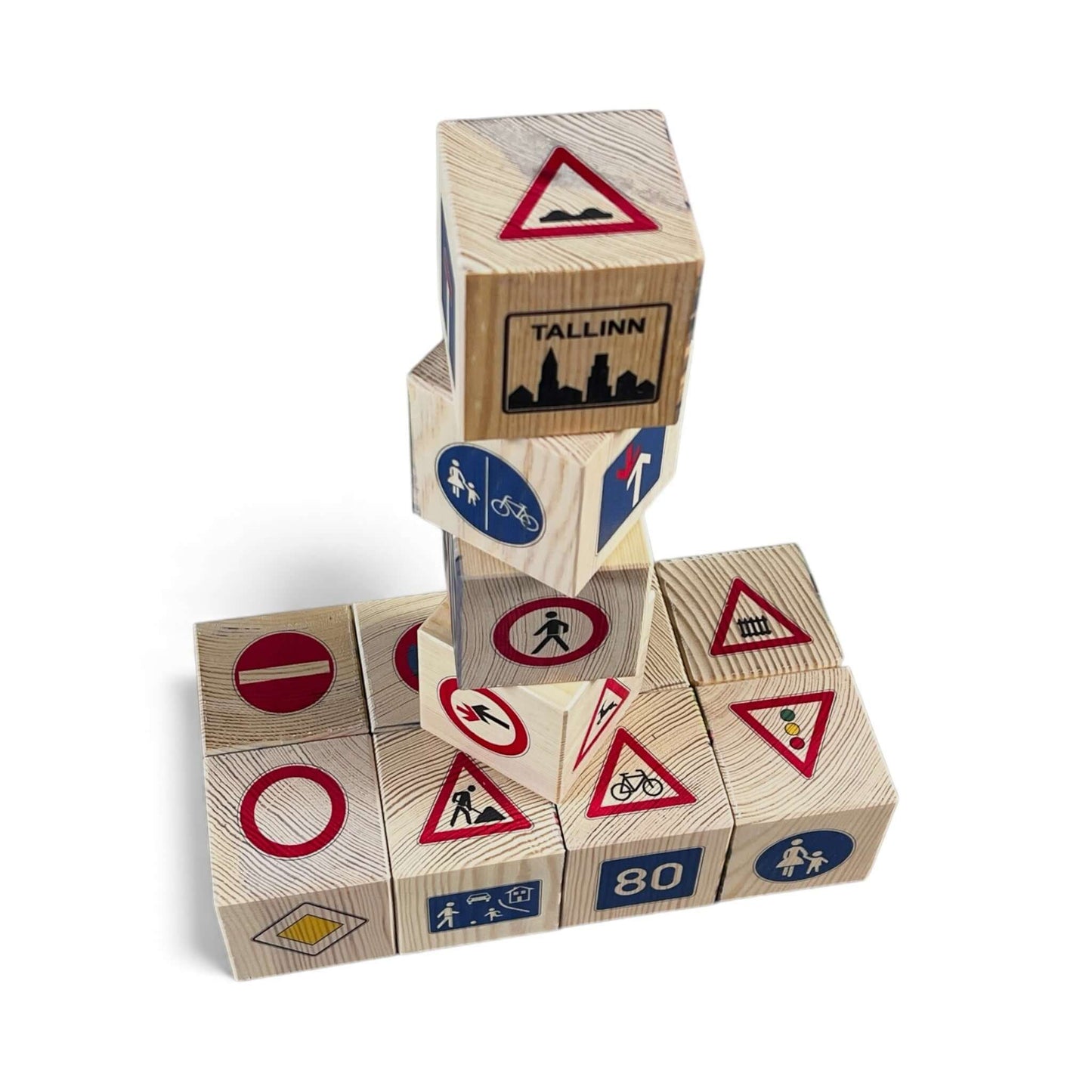 Stack of wooden blocks with road sign designs on a white background