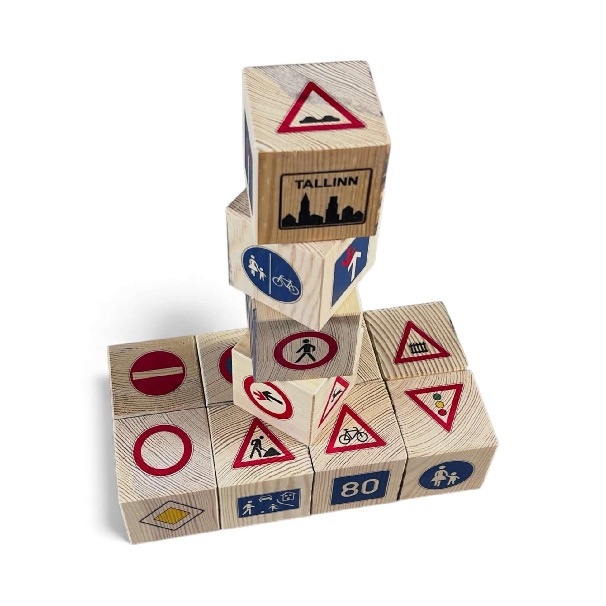 Stack of wooden blocks with road sign designs on a white background