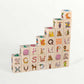 Wooden letter blocks - finnish alphabet - 30 pcs arranged in a staircase pattern, featuring colorful images and letters.