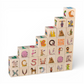 Wooden letter blocks - finnish alphabet - 30 pcs arranged in a staircase pattern, featuring colorful images and letters.