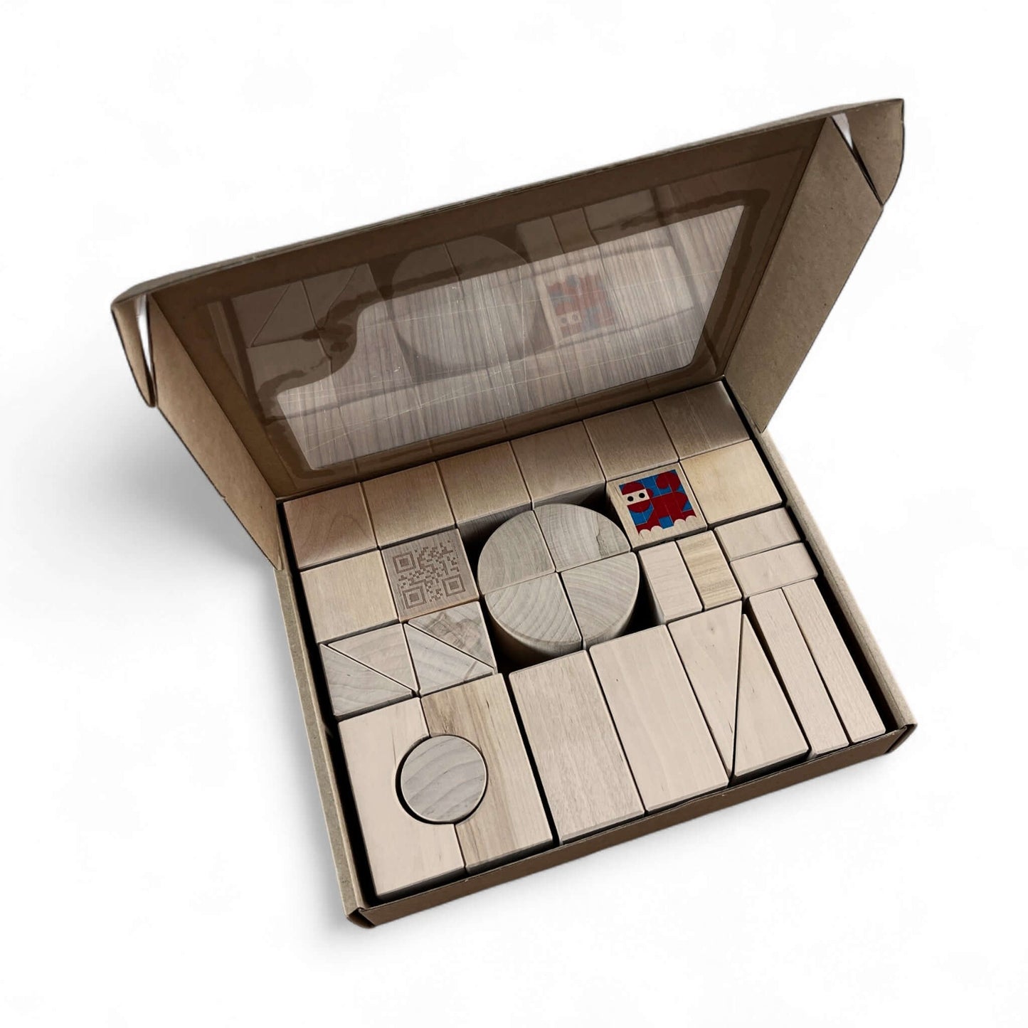 Wooden Toy Block Set – 31 Pieces in a cardboard box, showcasing various shapes and sizes of natural birch wood blocks.