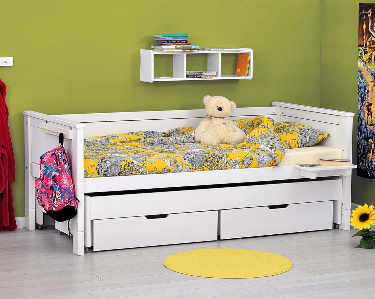 Jerwen - Compact bed - 90x200 cm with bright bedding and storage boxes underneath in a child's room.